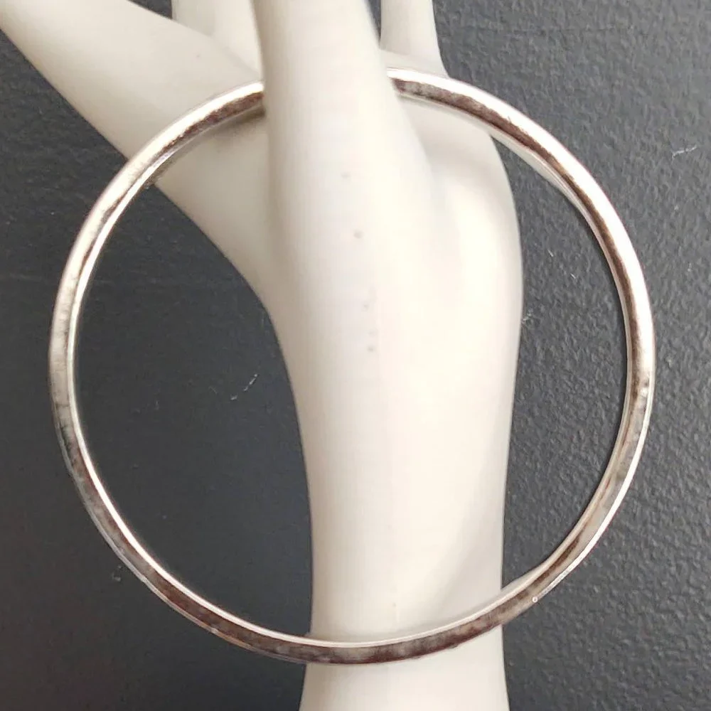Silver bangle with inlaid blue glass beads